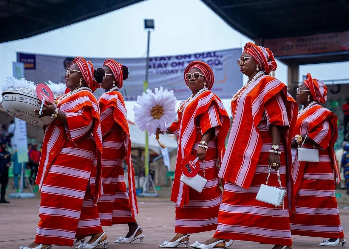 Regberegbe women in red and white aso-oke walking at Ojude Oba 2026
