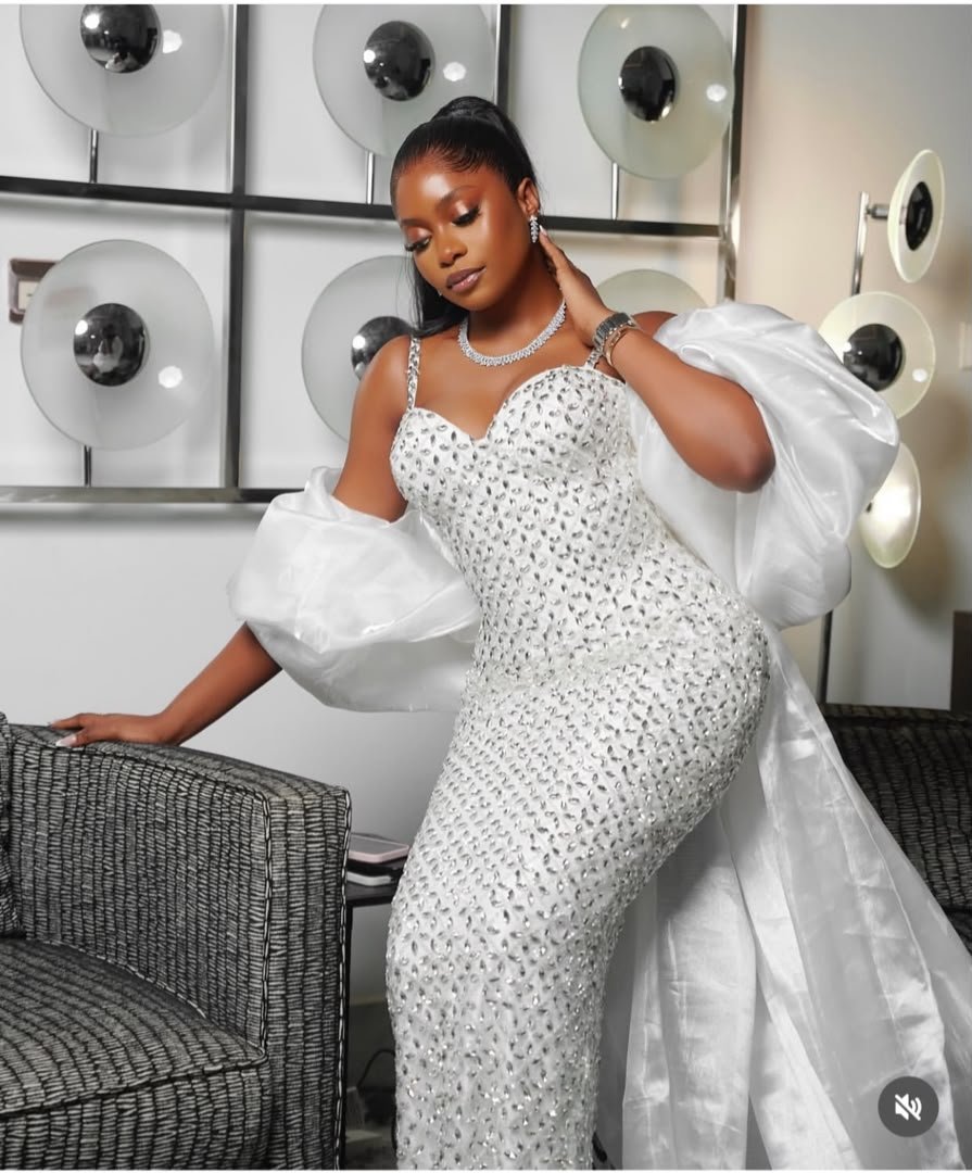 All-white wedding guest dress with architectural draping
