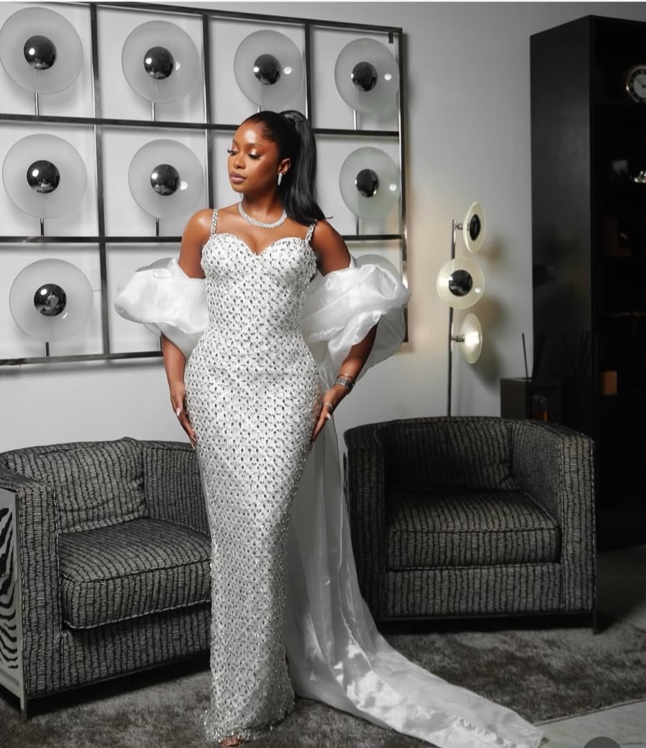 Bridal train in coordinated white and ivory ensembles